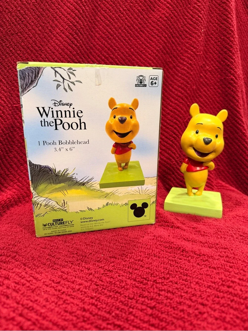 Disney Winnie the Pooh Yellow Figurine with Red Shirt and Green Base